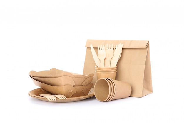 Eco - friendly tableware and paper bag isolated on white. Disposable dishes