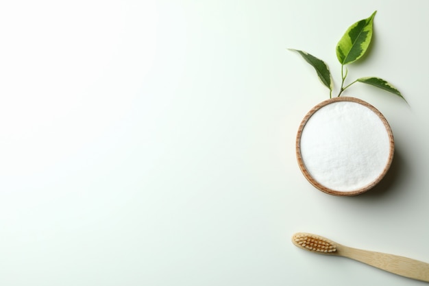 Eco friendly toothbrush and tooth powder on white background