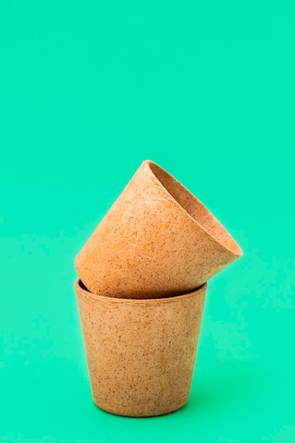 Eco-friendly type of cup - cone cups made from waffle on green background, vertical image