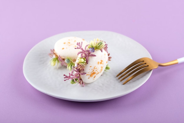 Eco macarons with flowers on plate high angle