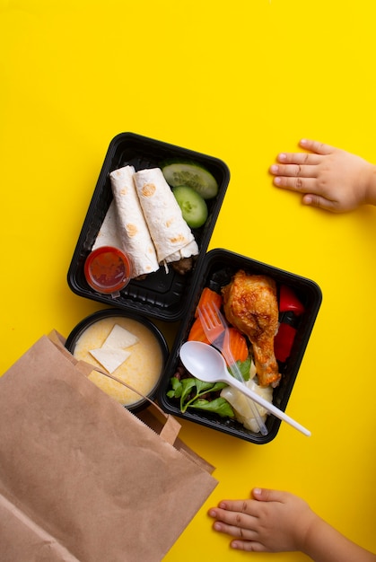 Eco paper bag with lunch boxes kids hands