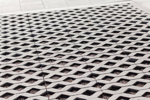 Eco Parking texture Floor. Floor stone tile with hole for grass. Parking of concrete cells and turf