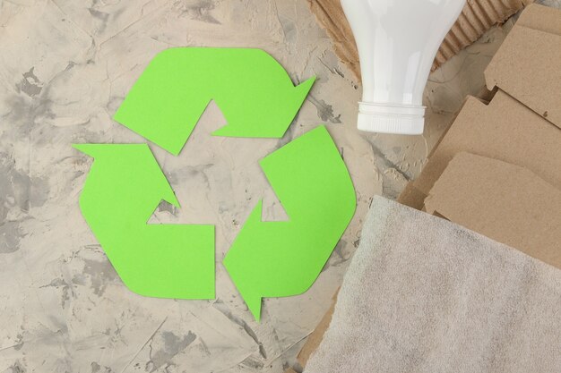 Foto simbolo ecologico. raccolta differenziata. concetto di eco sul tavolo in cemento chiaro. riciclo dei rifiuti. vista dall'alto.