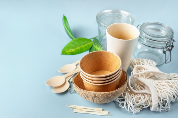 Eco tableware. Paper and bamboo cups, bag and wooden cutlery.