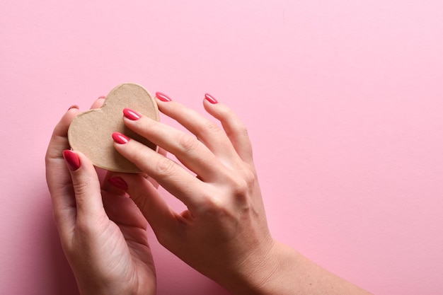 Ecobox in de vorm van een hart in de handen van een meisje Een cadeau voor Valentijnsdag