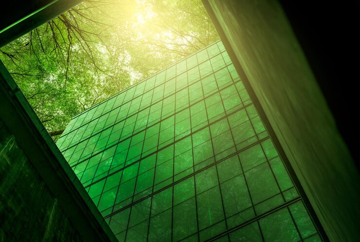 Ecofriendly building in the modern city Sustainable glass office building with tree