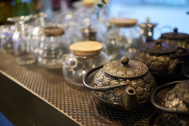 Ecofriendly dishes Empty glass cup and teapot with wooden lid on wicker tablemat