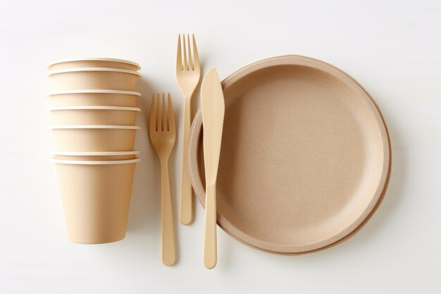 Ecofriendly utensils made of bagasse and bamboo on wooden table with white wall background Save the earth