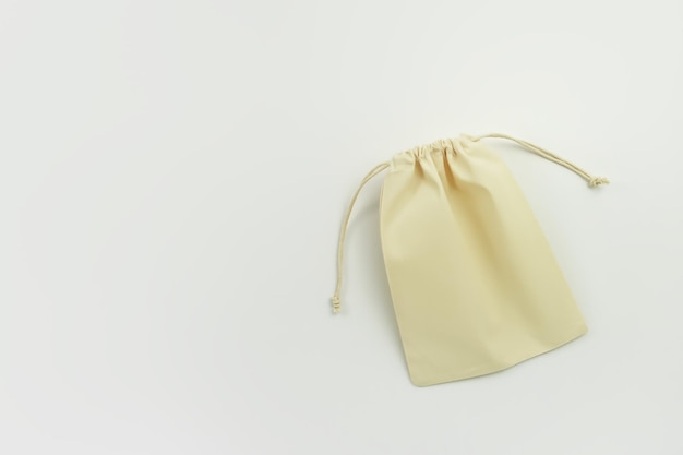 Photo ecofriendly yellow cotton bag with ties on white background