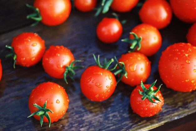 Ecological fresh farm cherry tomatoes on a wooden background