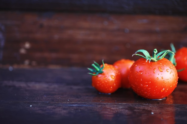 Ecological fresh farm cherry tomatoes on a wooden background