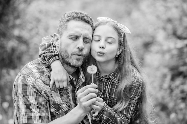 Ecology Happy family day spring village country family summer farm little girl and happy man dad earth day daughter and father with dandelion flower Transplanting plant Plant in soil