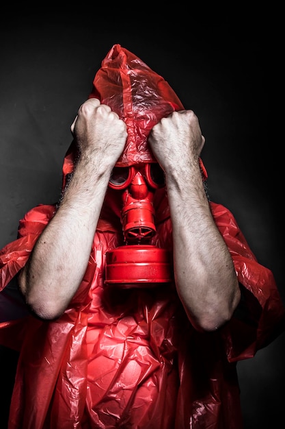 Ecology, A man in a gas mask over  the smoke. black background and red colors