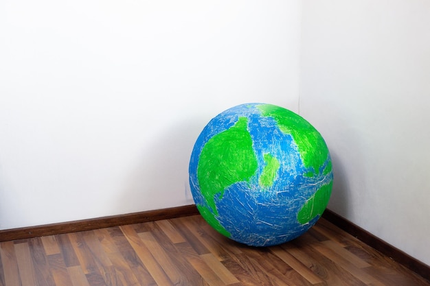 Ecoprobleem Planeet aarde in de hoek van de kamer Surrealisme