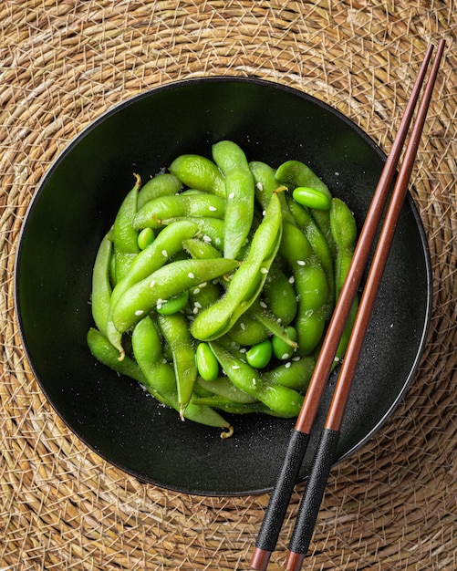 Edamame beans soybeans in a black bowl top view