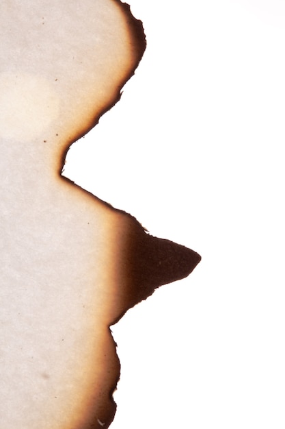 The edge of the burnt paper is insulated on a white background. High quality photo