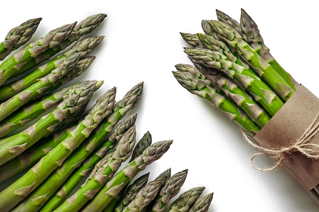 An edible raw stems of asparagus isolated on white background