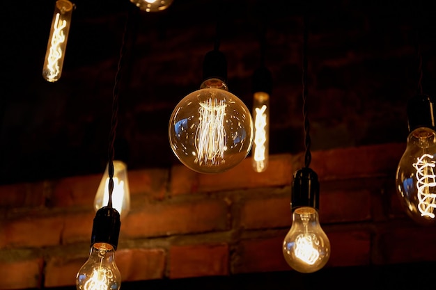 Edison light bulb hanging on a long wire Cozy warm yellow lightRetro