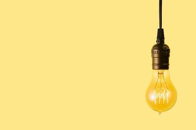 Edison light bulb on yellow