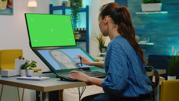 Editor retouching pictures and having green screen on computer. photographer using touch screen for image retouch while looking at chroma key with mockup template and isolated background