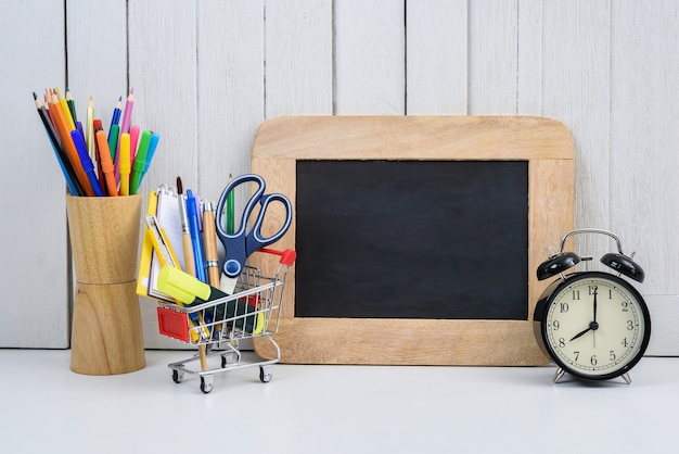 Education, Back to School, Shopping with shopping cart empty, chalkboard and alarm clock