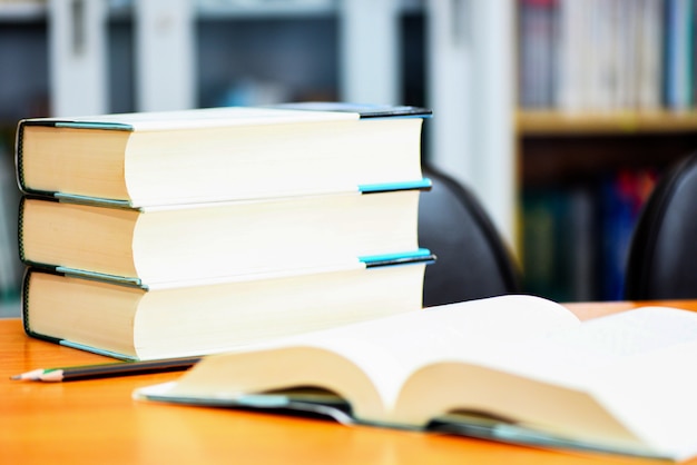 Education or back to school and study open book in library with book stacked on table