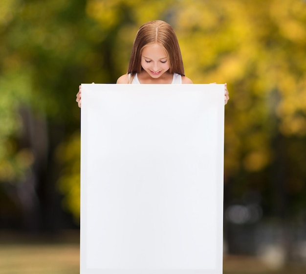 education and blank board concept - little girl with blank white board