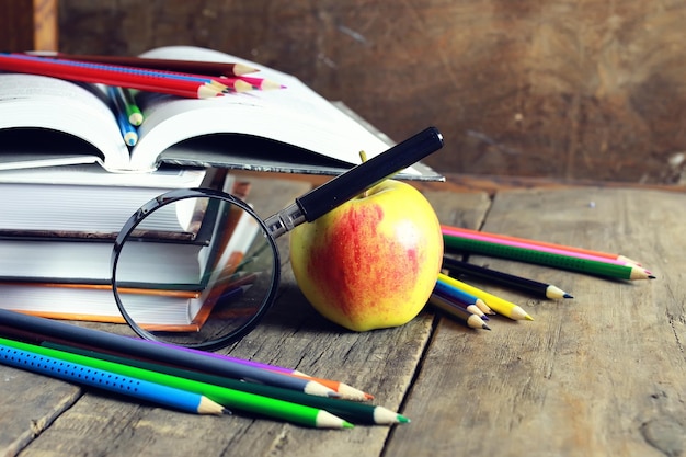 Education book apple and magnifying glass