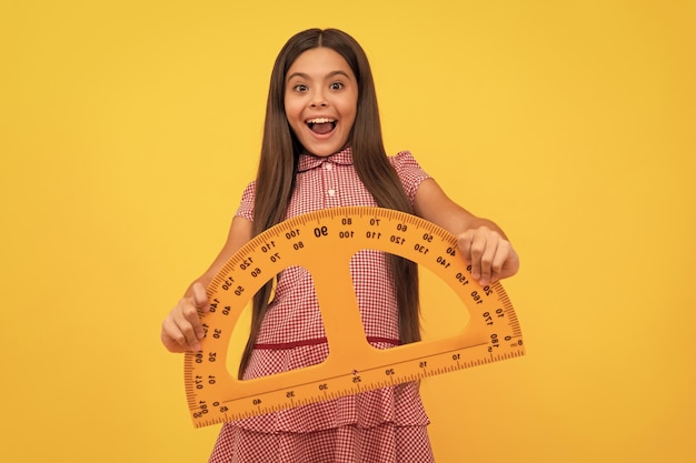 Education for child mathematics amazed teen girl hold protractor ruler back to school