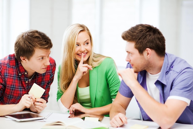 education concept - group of students gossiping at school