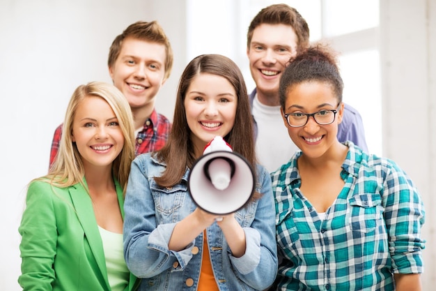 education concept - group of students with megaphone at school