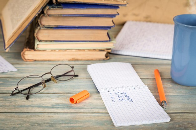 Education concept. Notebook page with the word  study on wooden table