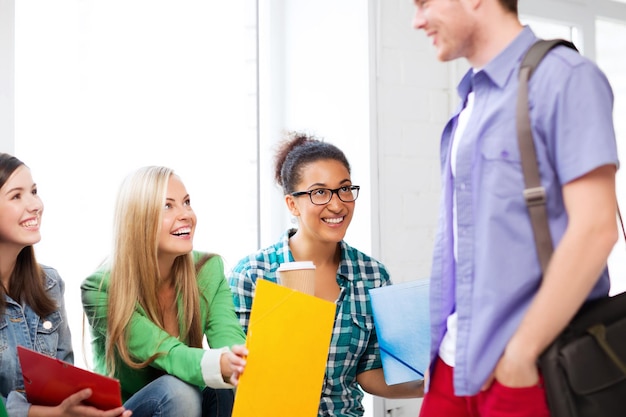 education concept - students communicating and laughing at school