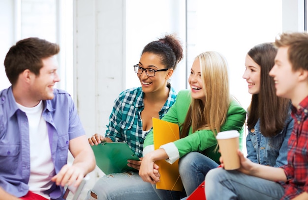 Photo education concept - students communicating and laughing at school