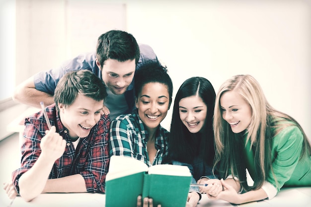 education concept - students reading book at school