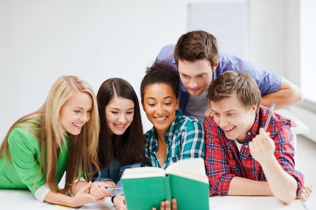 education concept - students reading book at school