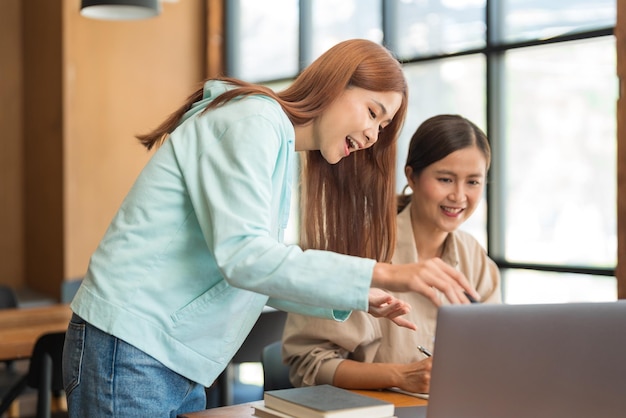 Education concept Teenage girl pointing on laptop to asking question tutor while study tutorial