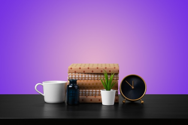 Education concept with stack of books on a table against colored background