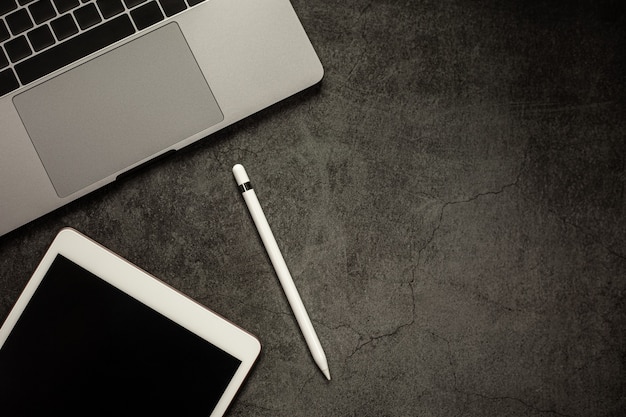 Photo education elearning concept blank screen tablet with notebook on black table background