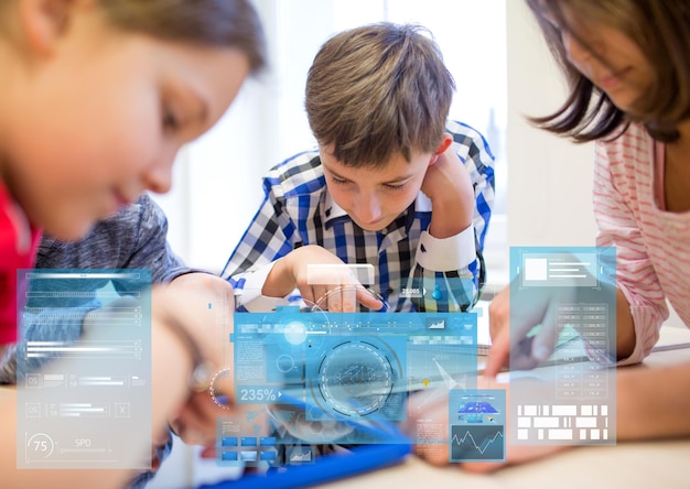 education, elementary school, learning, technology and people concept - group of kids with tablet pc computers in classroom over virtual screens projections