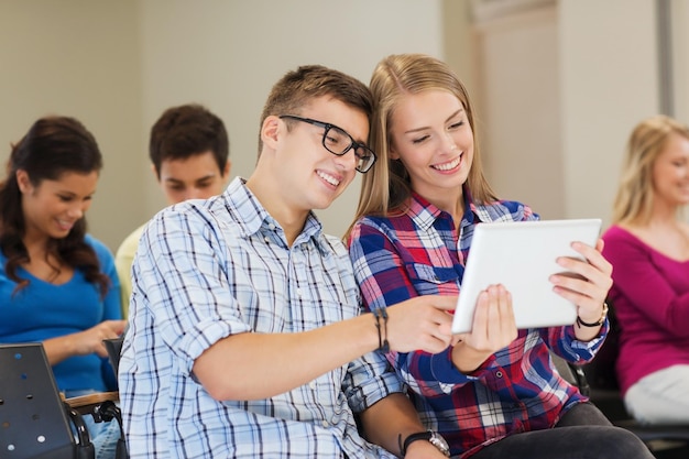 education, high school, teamwork and people concept - group of smiling students with tablet pc computers in lecture hall