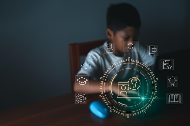 Education icon On the background of blurry pictures of boy is staring at a computer monitor.