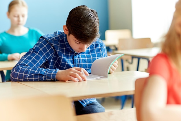 Photo education, learning and people concept - group of students with books writing school test