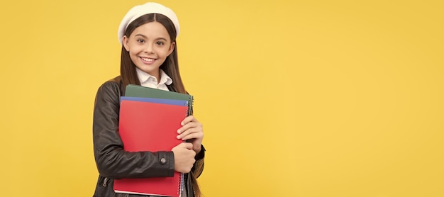 Education makes you different happy schoolchild hold books\
portrait of schoolgirl student studio banner header school child\
face copyspace