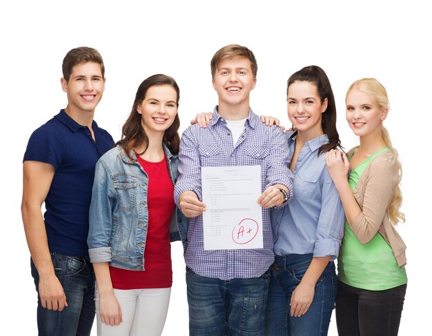 education and people concept - group of smiling students standing and showing test result