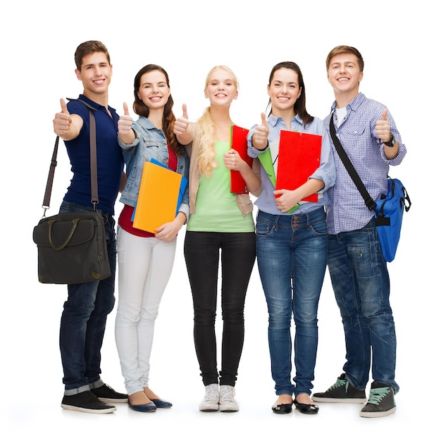 education and people concept - group of smiling students standing and showing thumbs up