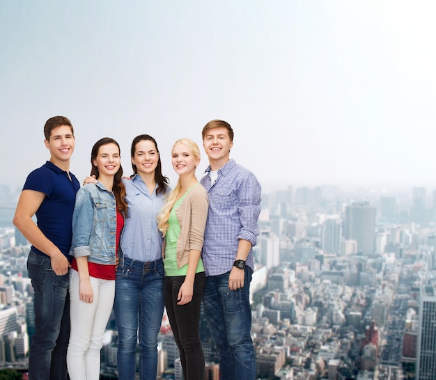 education and people concept - group of smiling students standing