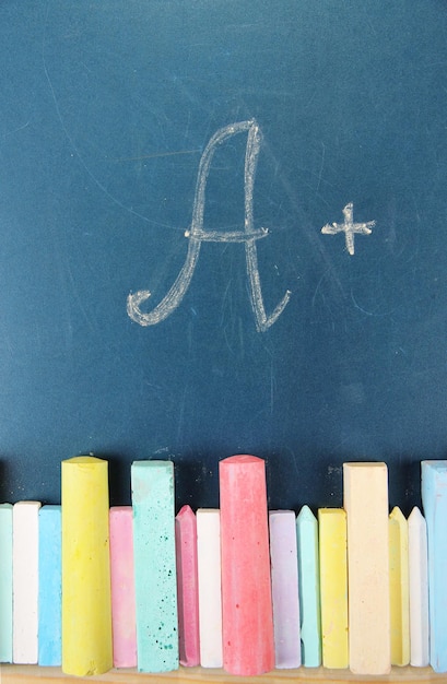 Education rating and colorful chalks on school desk