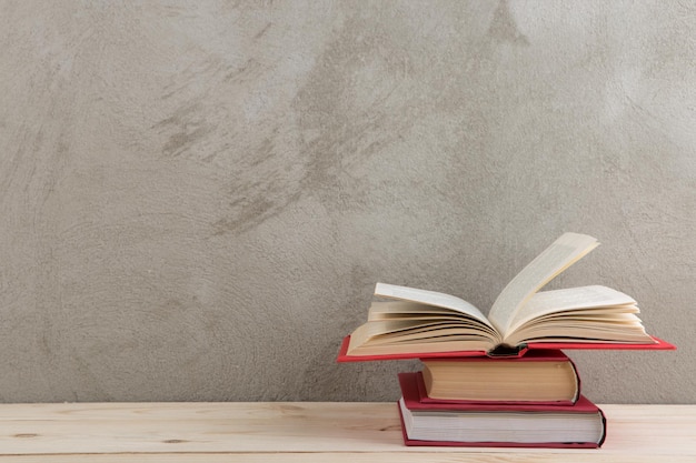 books in background Photo education and reading concept group of colorful books on the wooden table concrete wall blackboard