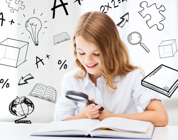 education and school concept - little student girl reading book with magnifier at school